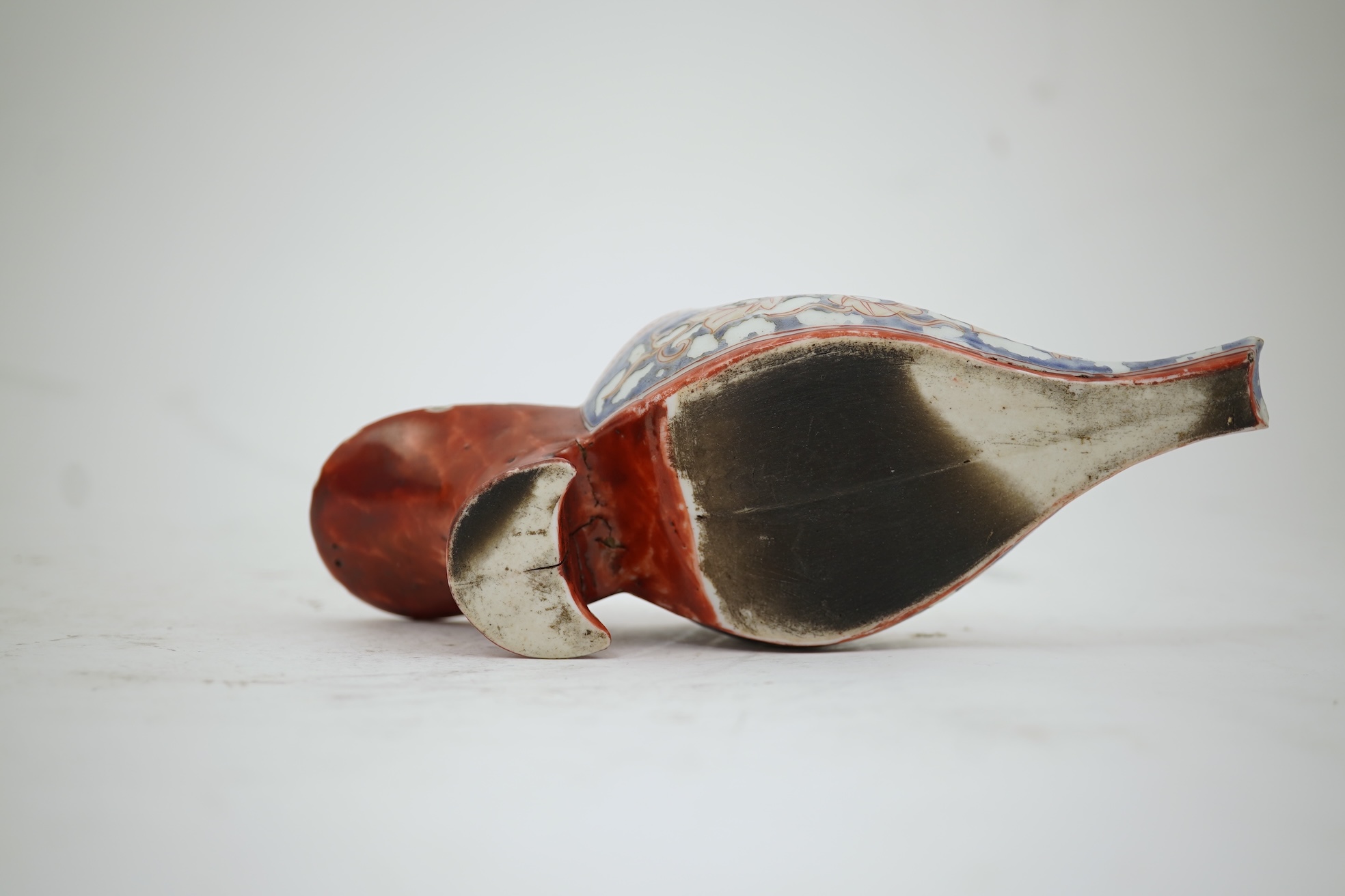 A rare Japanese Arita or Chinese porcelain model of a shoe, based on a Delft shape, first half of 18th century